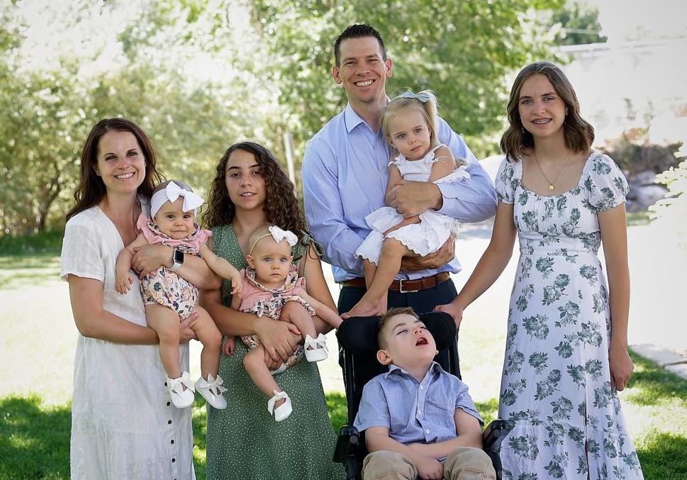 image of a family standing outsite